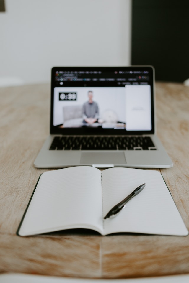 An image of someone viewing an online meeting on a laptop.