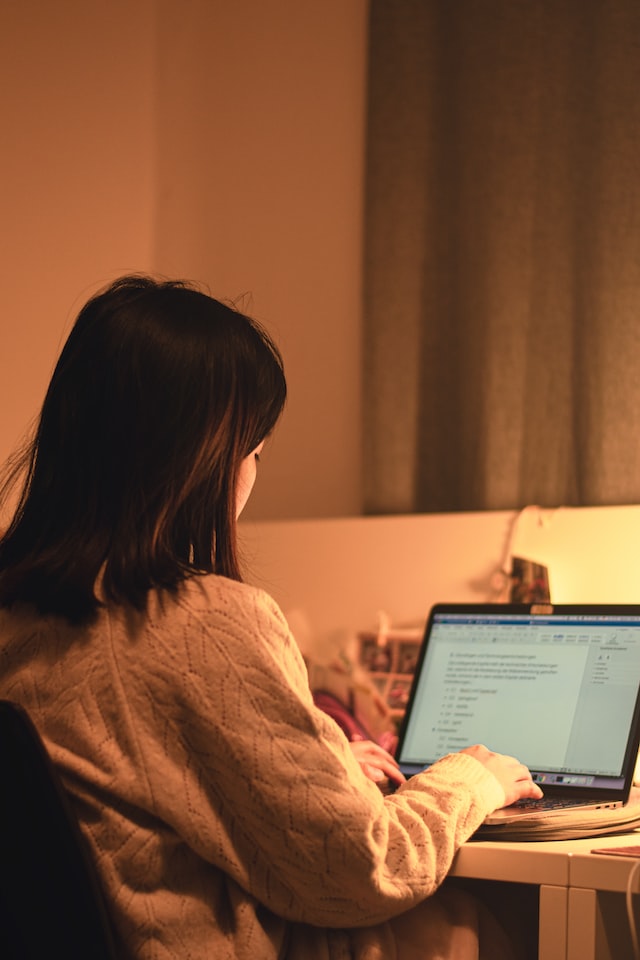 An image of a woman studying at her desk.